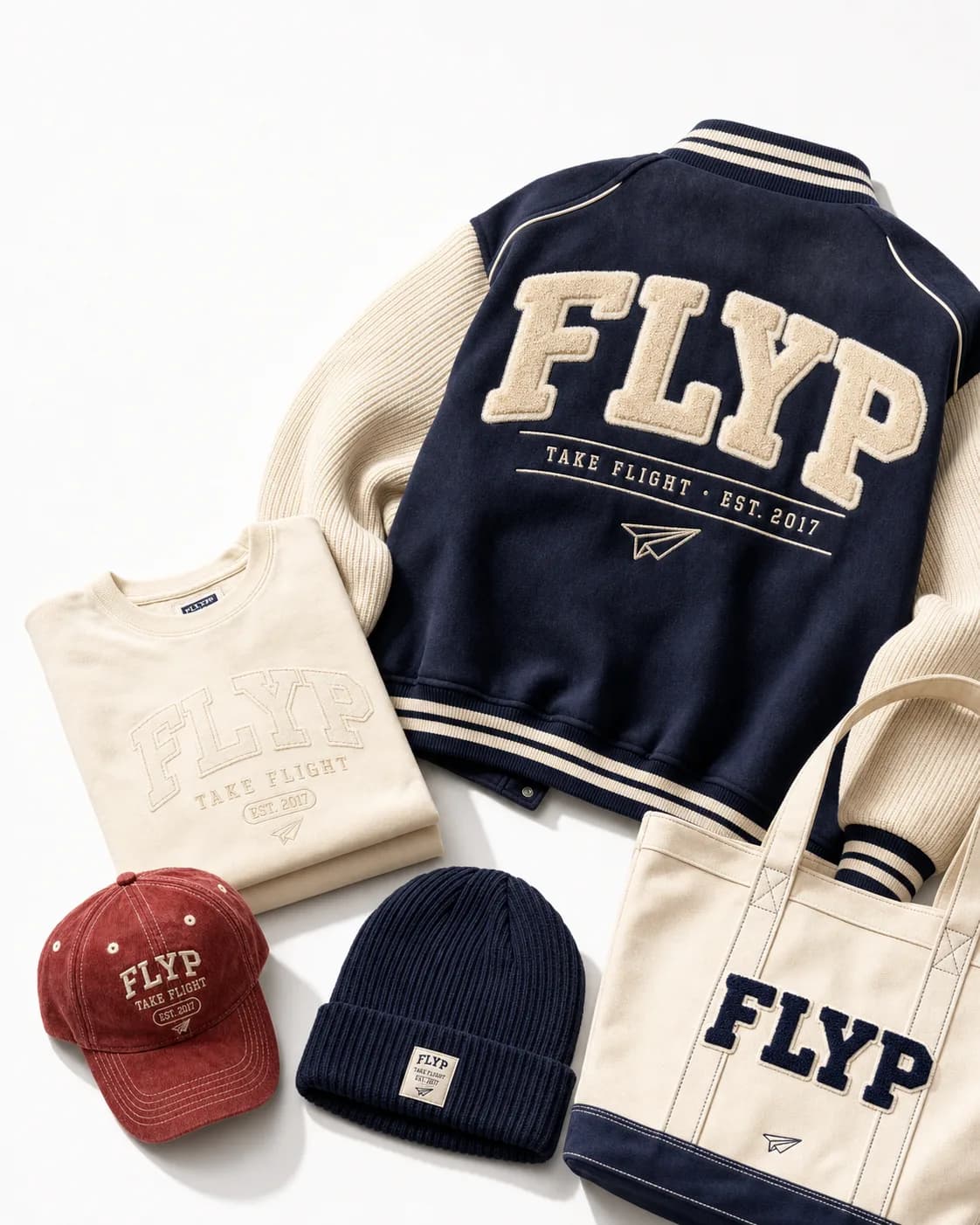 FLYP-branded kit — varsity jacket, sweatshirt, cap, beanie and tote