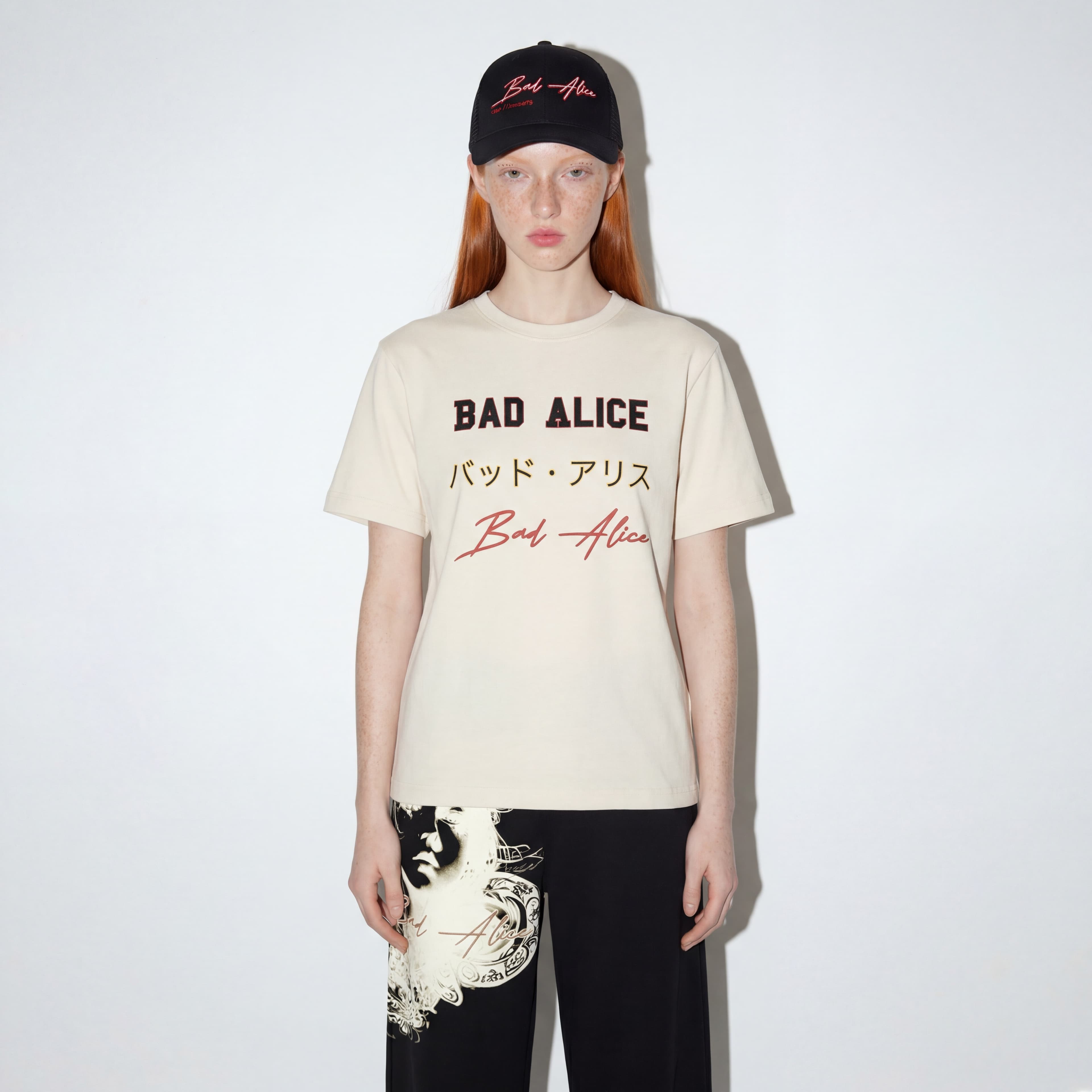 Model wearing Bad Alice branded tee with cap